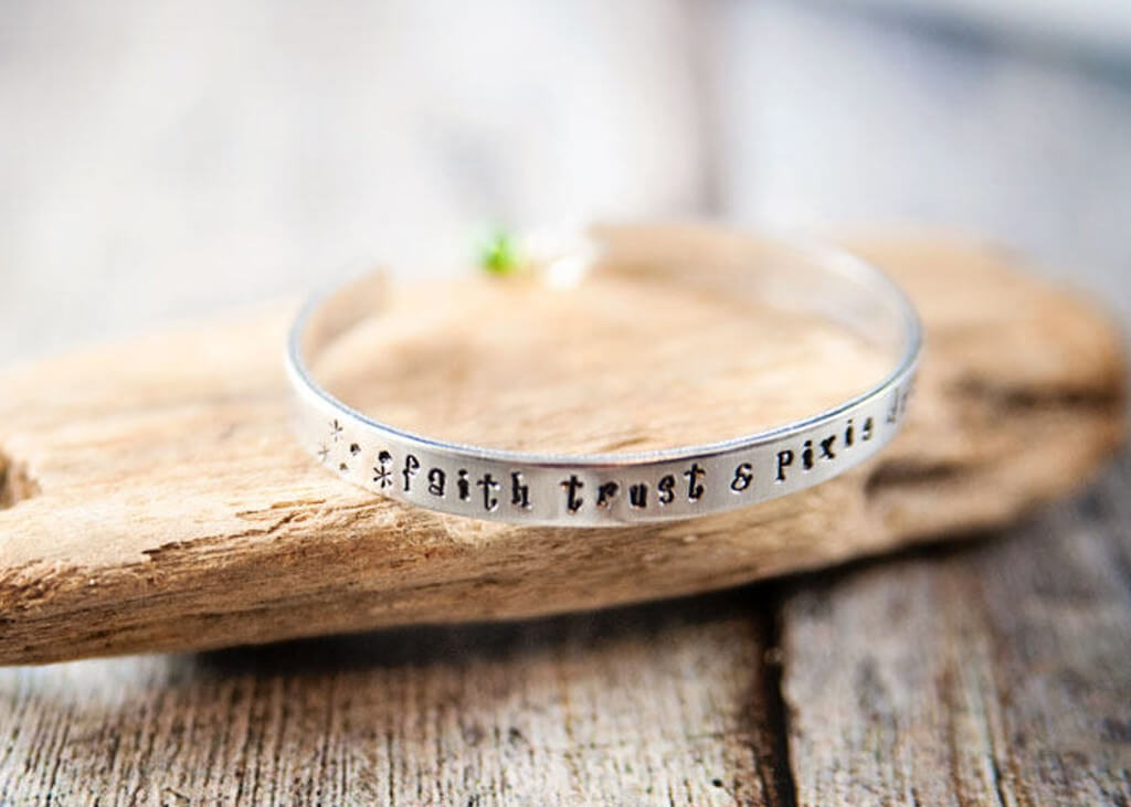 Silver bracelet with the quote "Faith, Trust, and Pixie Dust"