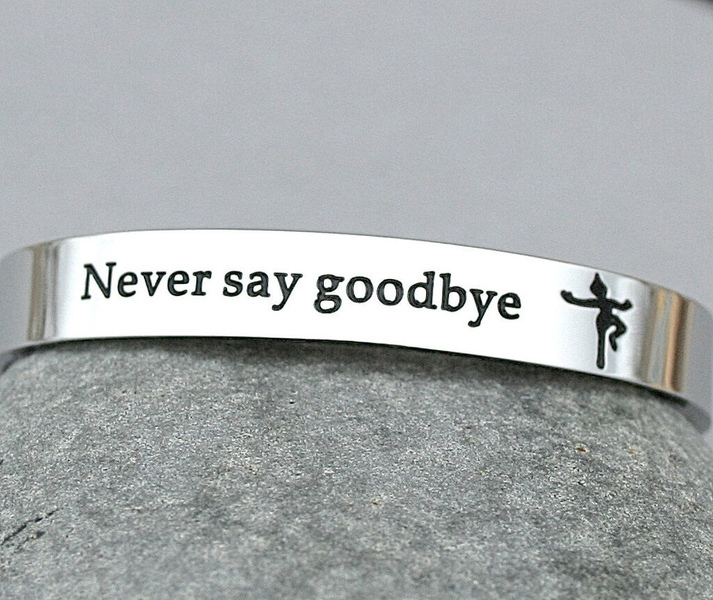Cuff bracelet with the phrase "Never say goodbye" and a little Peter Pan silhouette engraved on it