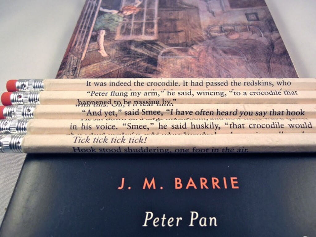 Five pencils wrapped in pages from a Peter Pan book