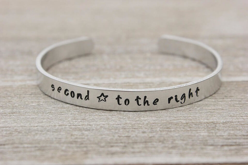 Cuff bracelet with the phrase "second star to the right" engraved on it