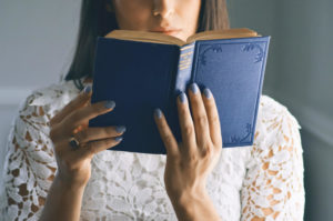 A woman reading a blue book