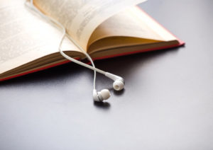 White earbuds sitting on a book