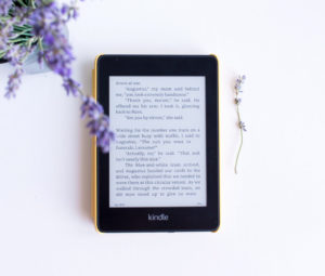 Kindle and purple flower flatlay