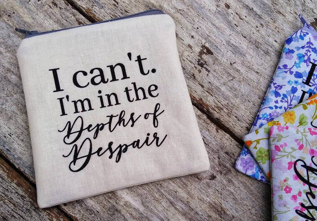 Linen pouch that reads "I can't. I'm in the Depths of Despair" by Petalz and Finz