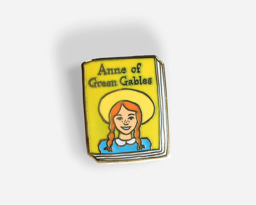 Yellow and blue Anne of Green Gables book-shaped enamel pin by Jane Mount