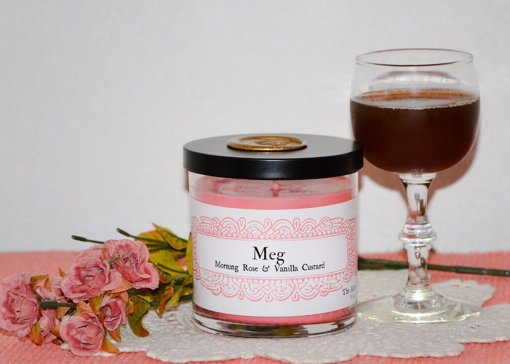 Pink candle with the words "Meg" and "Morning Rose & Vanilla Custard" written on it. By Recto and Verso