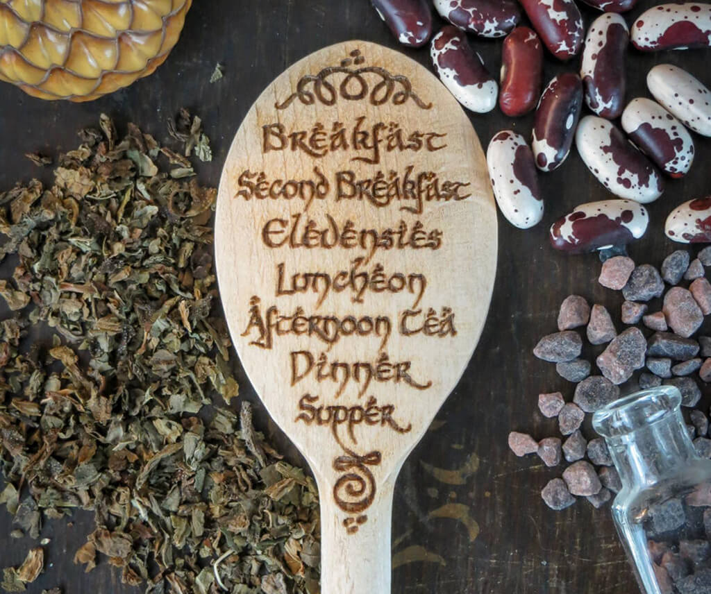 Wooden spoon with the text "Breakfast, second breakfast, elevensies, luncheon, afternoon tea, dinner, supper" written on it. By Adventure Awaits Us