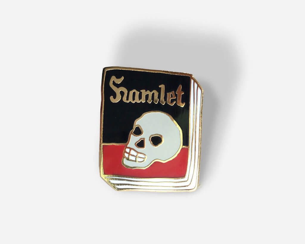 Hamlet Book Enamel Pin with a skull on the front by Jane Mount
