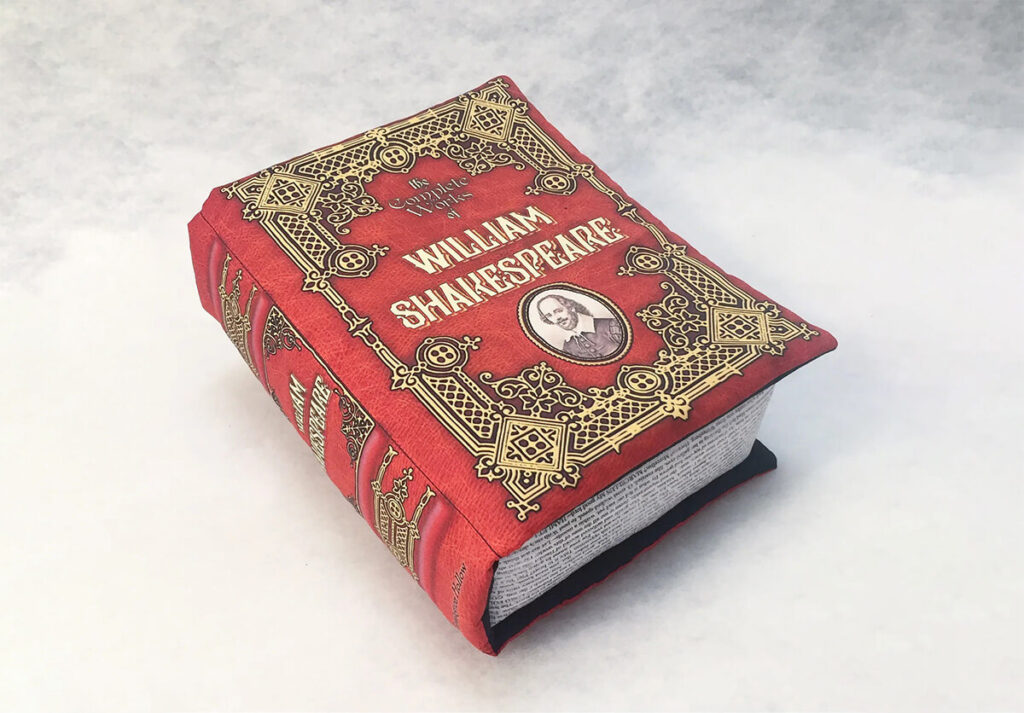Book-shaped pillow that says "William Shakespeare" by BrassingtonHollow