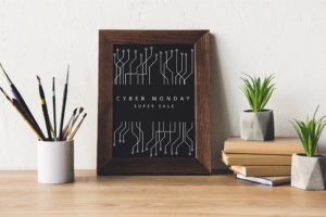 Book stack next to a sign that reads "Cyber Monday"