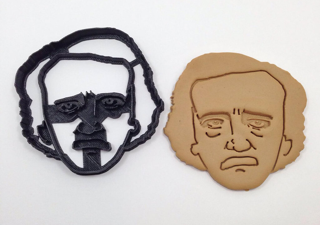 Black cookie cutter of Edgar Allan Poe's face next to a cookie of his face. By Boe Tech LLC