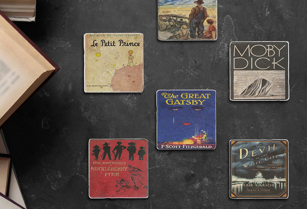 Five coasters with classic book covers, including the iconic blue book cover of The Great Gatsby. By Black Angel Chicago