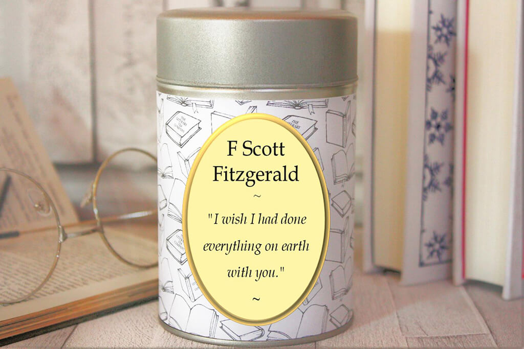 Cylinder tea tin that reads "F Scott Fitzgerald" and "I wish I had done everything on earth with you." By Literary Tea Company