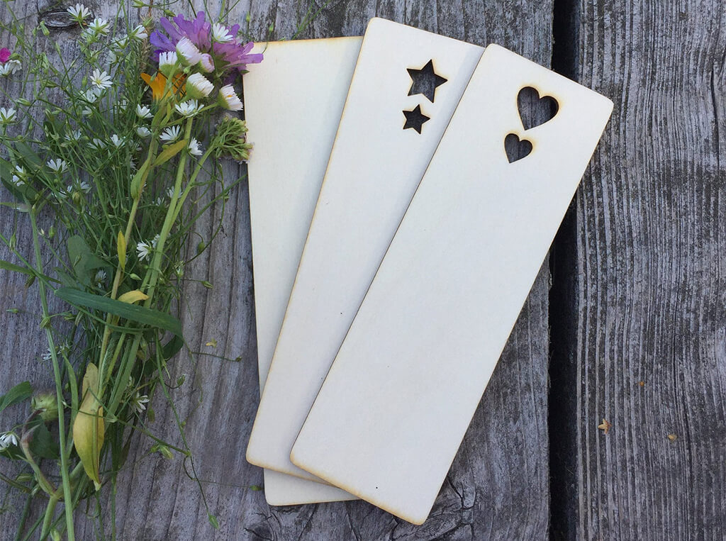 Three blank wooden bookmarks, one with stars cut out of the top and one with hearts cut out of the top. By Jo Craft Shop