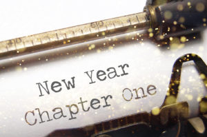 Typewriter with paper that reads "New Year Chapter One"