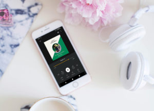 Phone and headphone flatlay with Anne of Green Gables audiobook