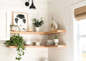 Wooden floating bookshelves in the corner of a room by Ultra Shelf