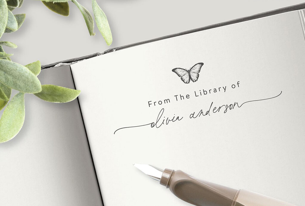 Stamp on book with a butterfly design on top and the words "From the library of [name]" on the bottom. By VanlittleStudio