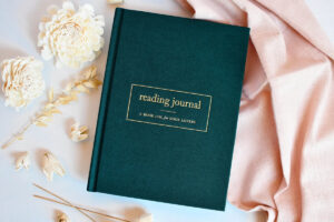 Green journal that says "reading journal" on it by Duncan and Stone