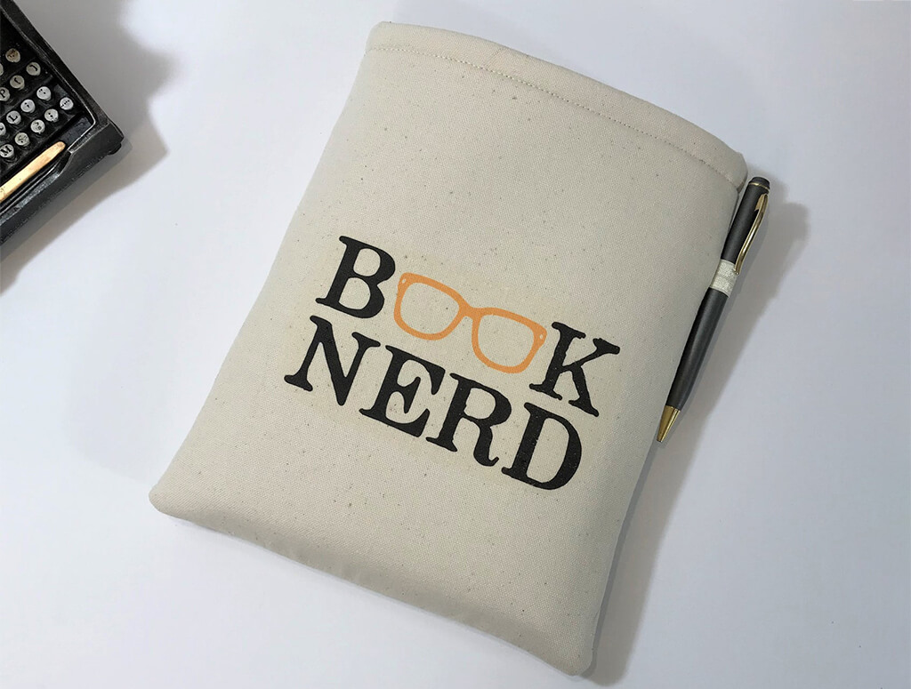 Canvas book sleeve with the word "Book Nerd" written on it and a pair of glasses forming the "oo" in "book". By LukieDukie