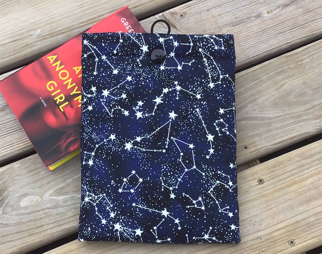 Dark blue book sleeve with constellation and stars pattern by Fabric Bound