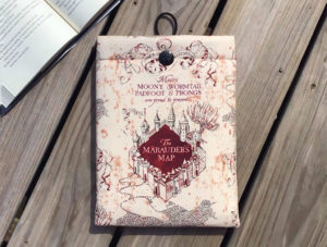 Book sleeve with a design that reads "Marauder's Map" by Fabric Bound