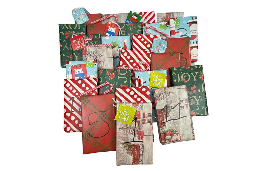 Books wrapped in Christmas wrapping paper by NeverlandBooksUS