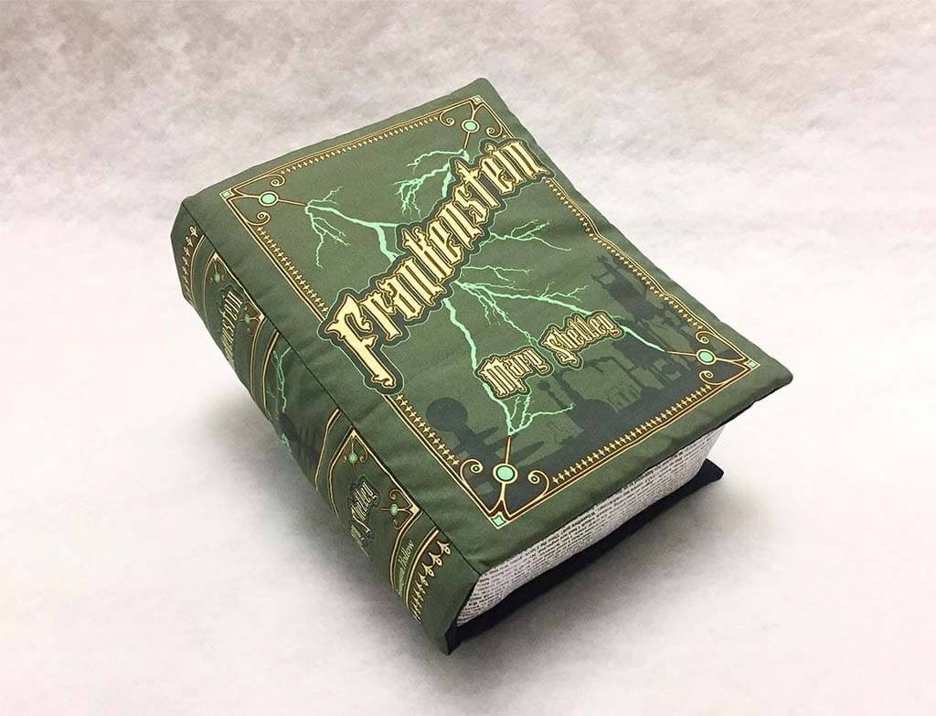 Green pillow shaped like a book with the word "Frankenstein" on it. By BrassingtonHollow