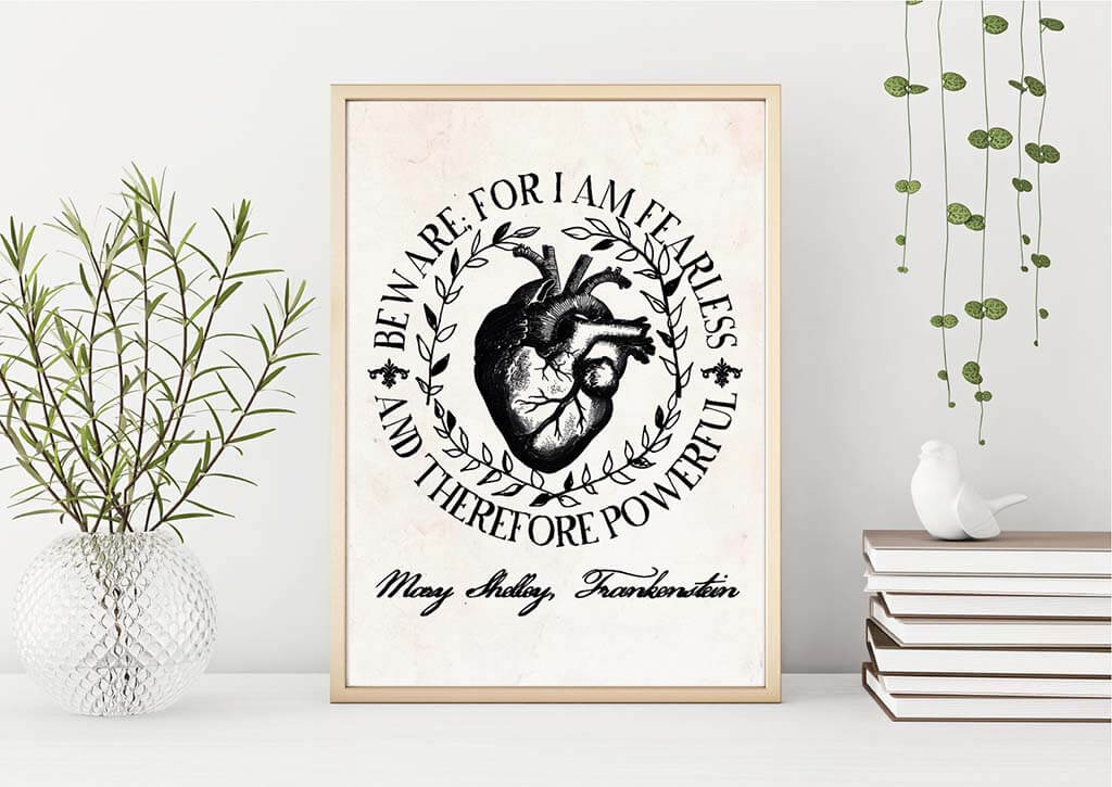 White art print with an image of a heart and the words "Beware for I am fearless, and therefore powerful" encircling it. By LittleLibraryCo
