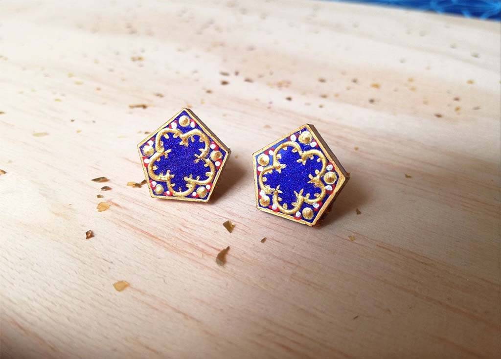 Blue hexagon earrings with scrollwork around the edges by SalomeArtistic