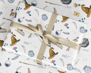 Wrapping paper with wizard items like sorting hat, glasses, potions, and more by MiMiPrintCo