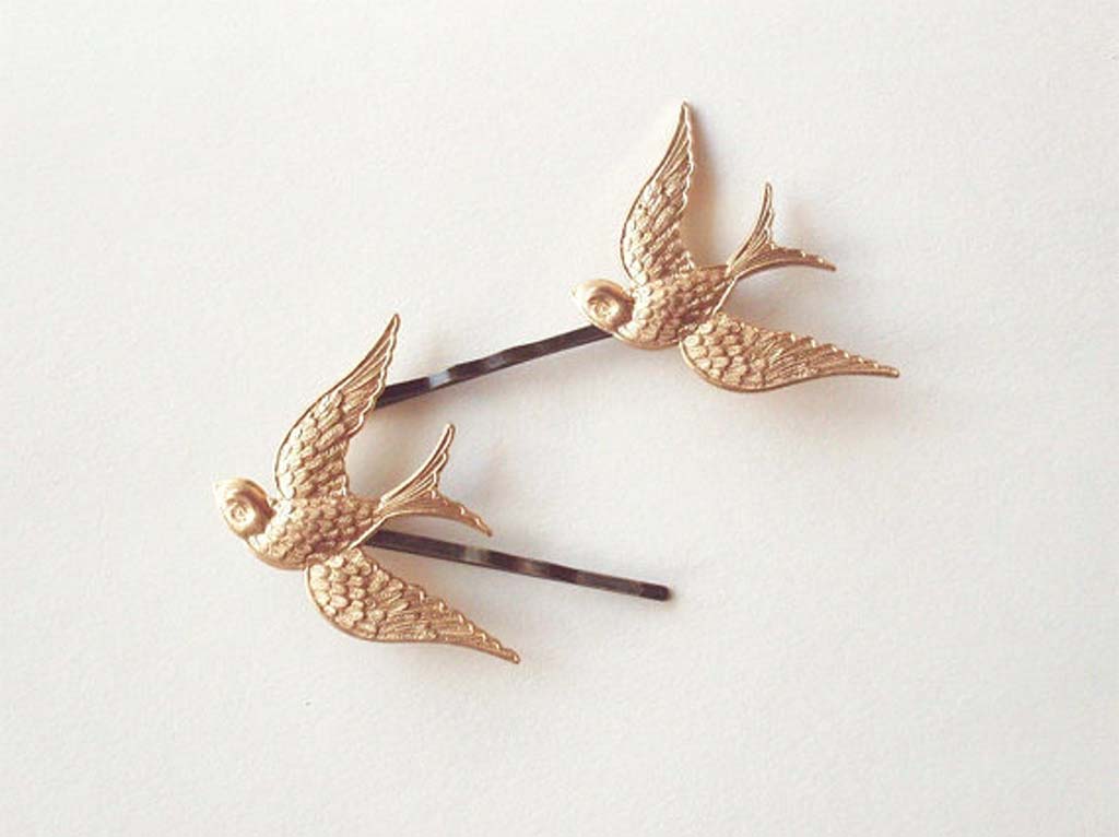 Gold-colored bird bobby pins that look like mockingjays by DreamsByTheSea