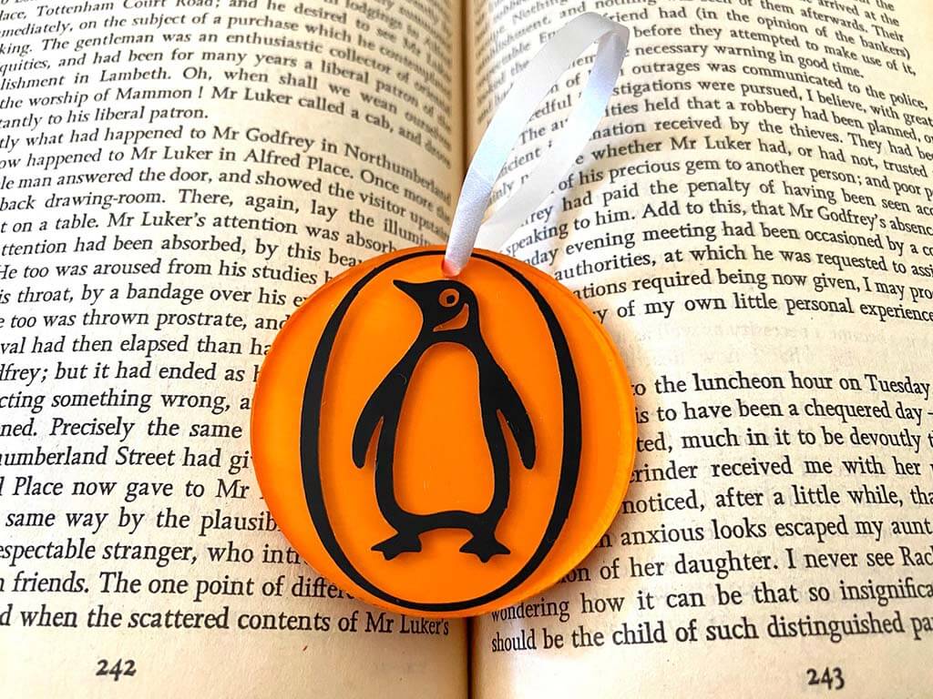 Orange ornament with the Penguin Classics logo by AppalachianThreadCo