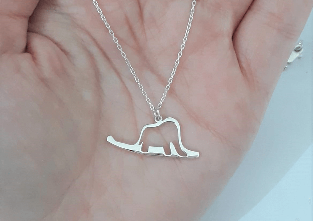 Necklace pendant shaped like a hat or a boa with an elephant inside by Silverelydesigns