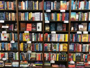 Wooden shelves filled with colorful books in a bookstore