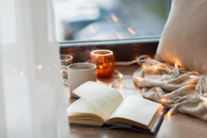 Open book with candles and string lights