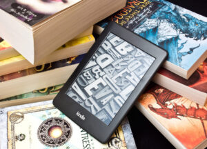 Kindle sitting on top of closed books