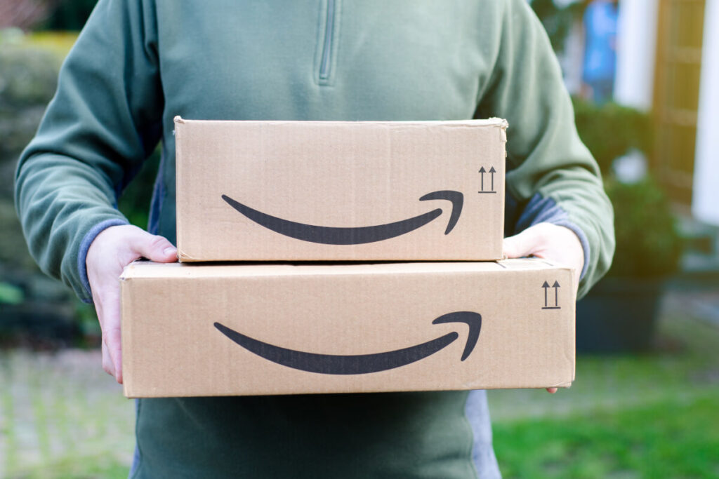A man holding two Amazon boxes