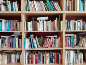 Picture of full bookshelves with slightly messy shelves