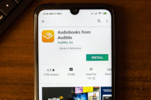 A phone sitting on a table with the Audible app open on the Play store