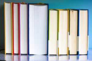 Colorful books in a row with their pages facing the camera