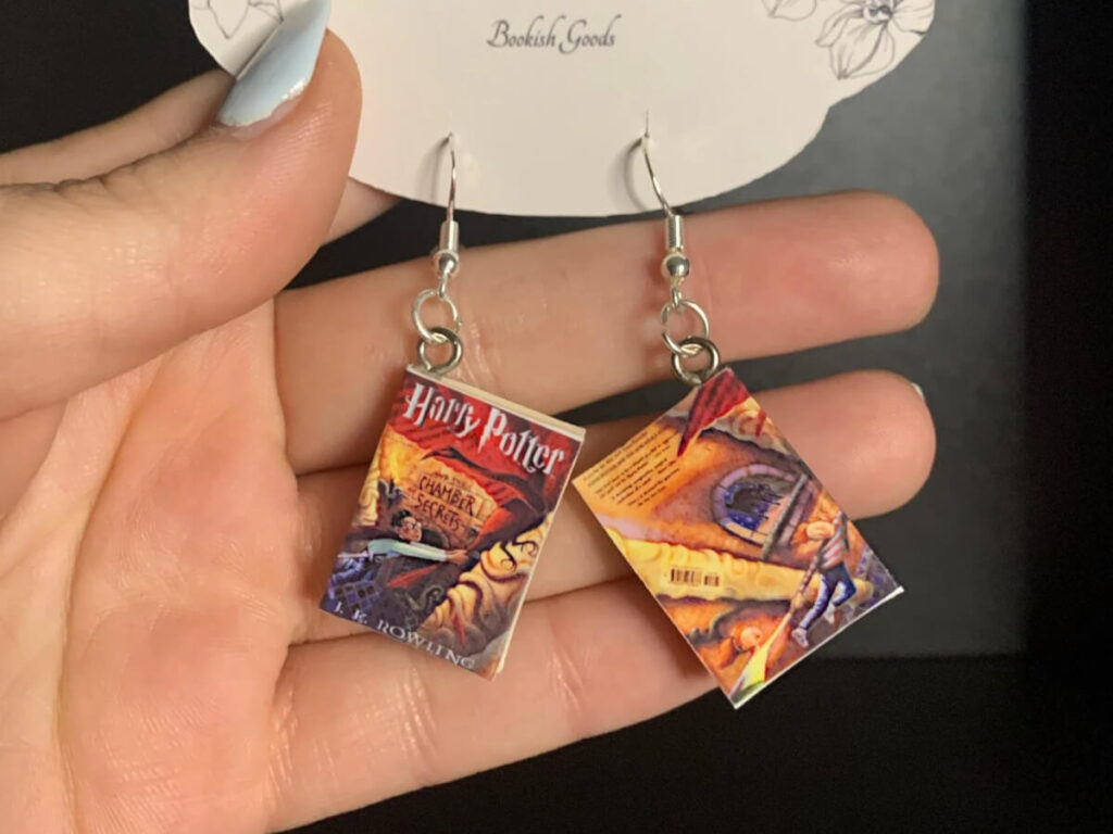 Book-shaped earrings with artwork to look like the cover of Harry Potter and the Chamber of Secrets. By BellesBookCorner