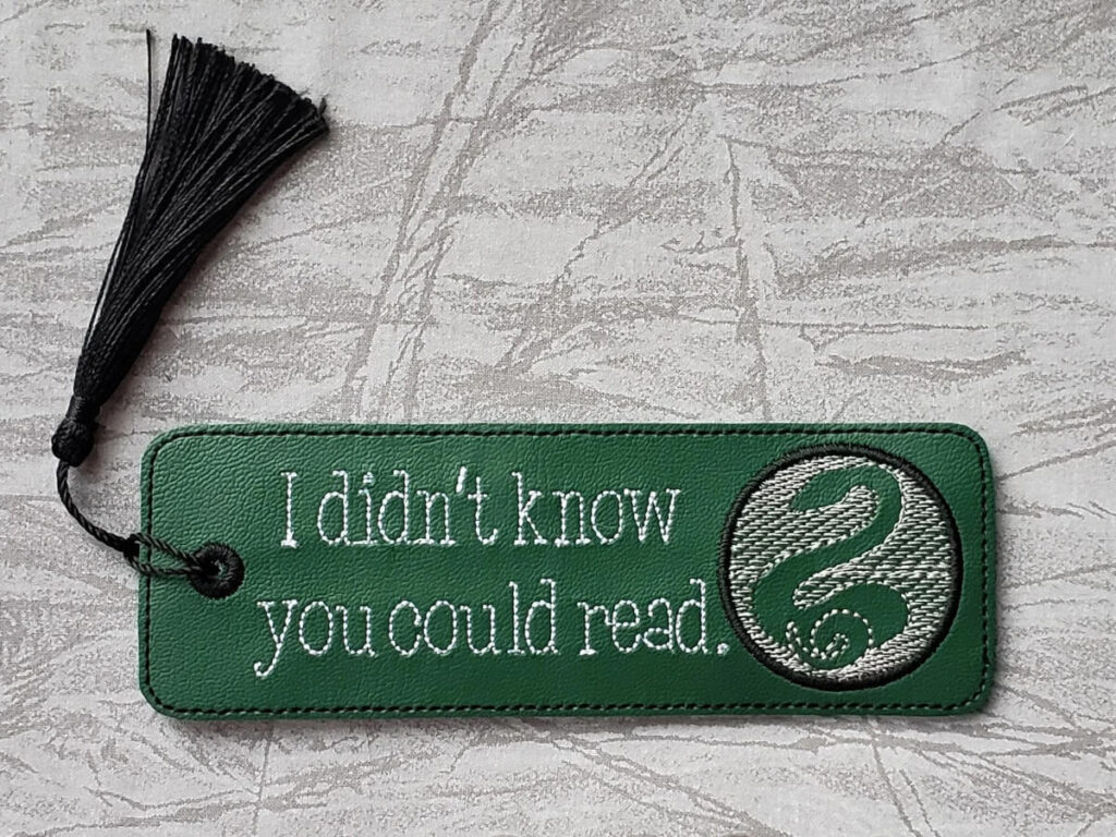 Green bookmark with snake symbol that reads "I didn't know you could read" by SoBeStitching