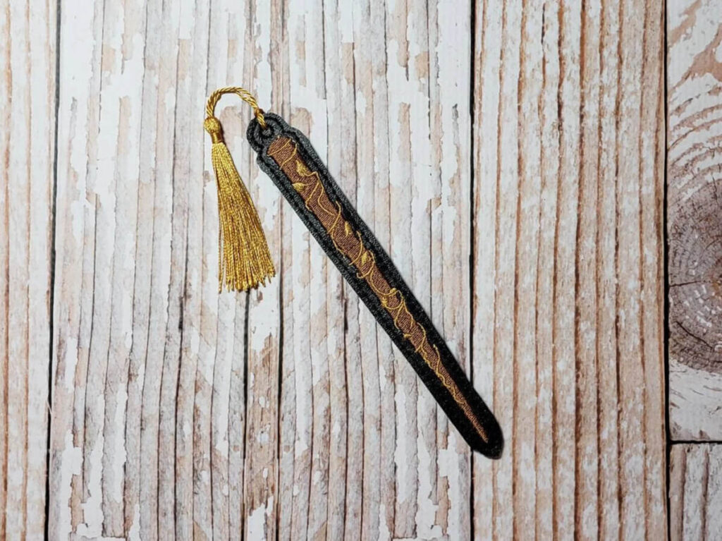 Bookmark shaped like a wizarding wand, with a tassel. By RoyallyTwistedBtq
